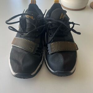 Nike Black and Gold Athletic Shoes with Streamlined Design